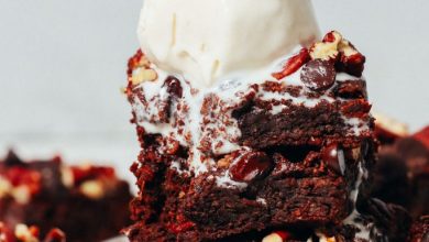 Vanilla ice cream melting down from a stack of Fudgy Sweet Potato Brownies